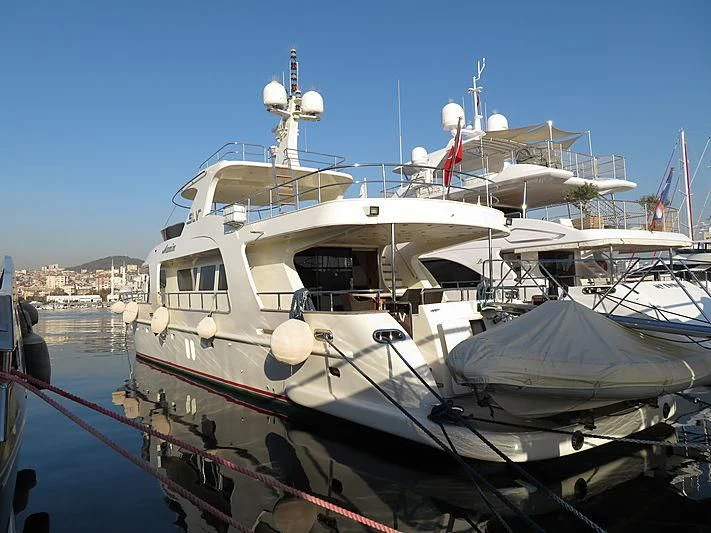 a boat docked at a pier aboard AZMIM Yacht for Sale