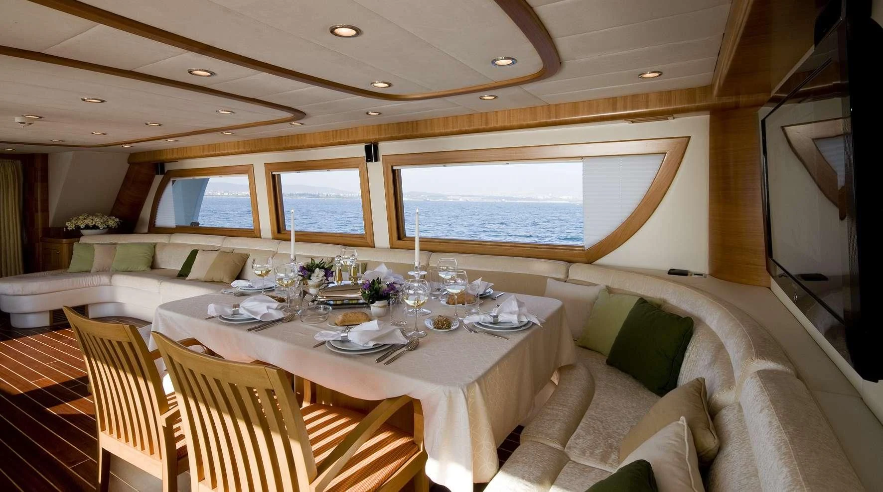 a dining table in a room aboard AZMIM Yacht for Sale