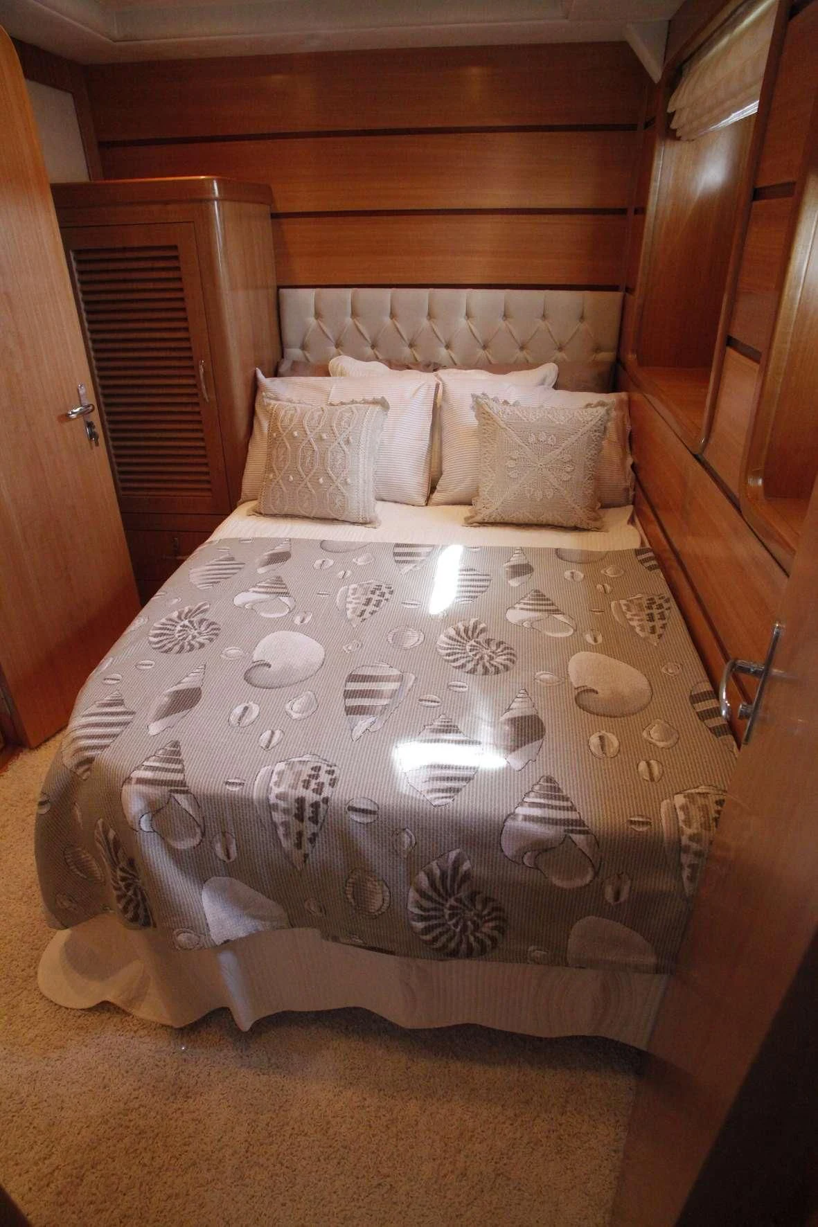 a bed with a white sheet and pillows aboard AZMIM Yacht for Sale