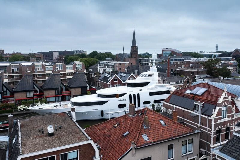 a large white boat in a city aboard ACTA Yacht for Charter