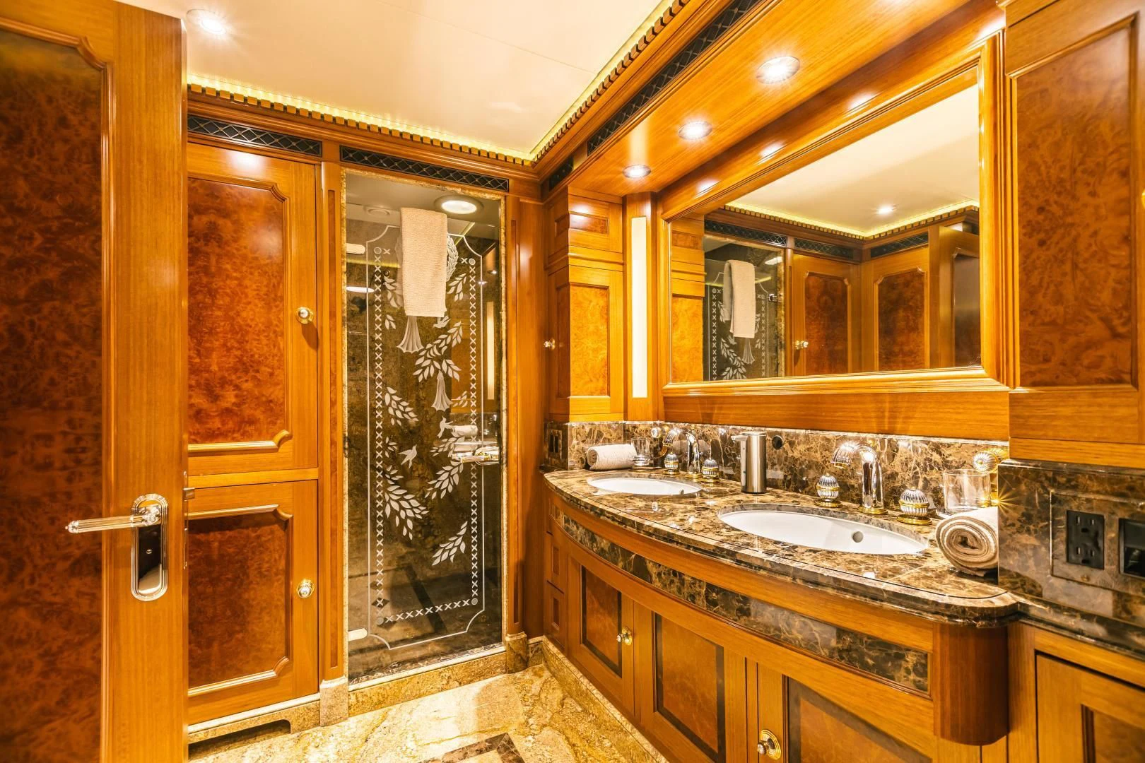 a bathroom with a large mirror aboard ACTA Yacht for Charter