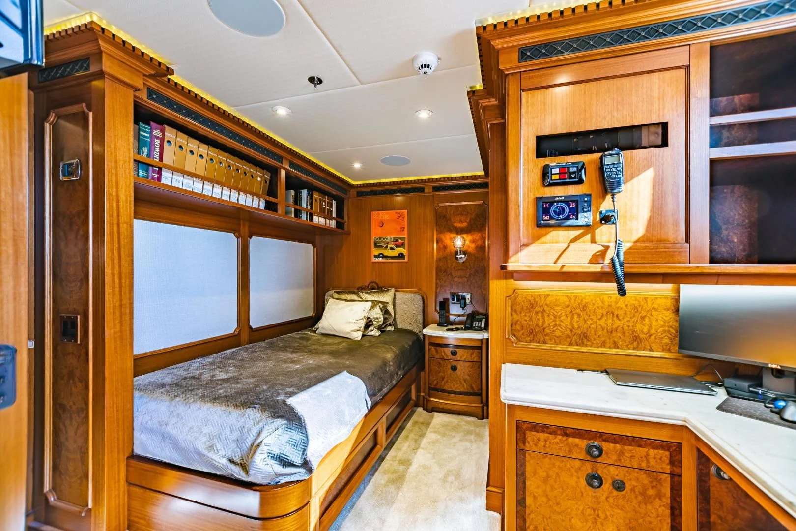 a bedroom with a bed and a desk aboard ACTA Yacht for Charter