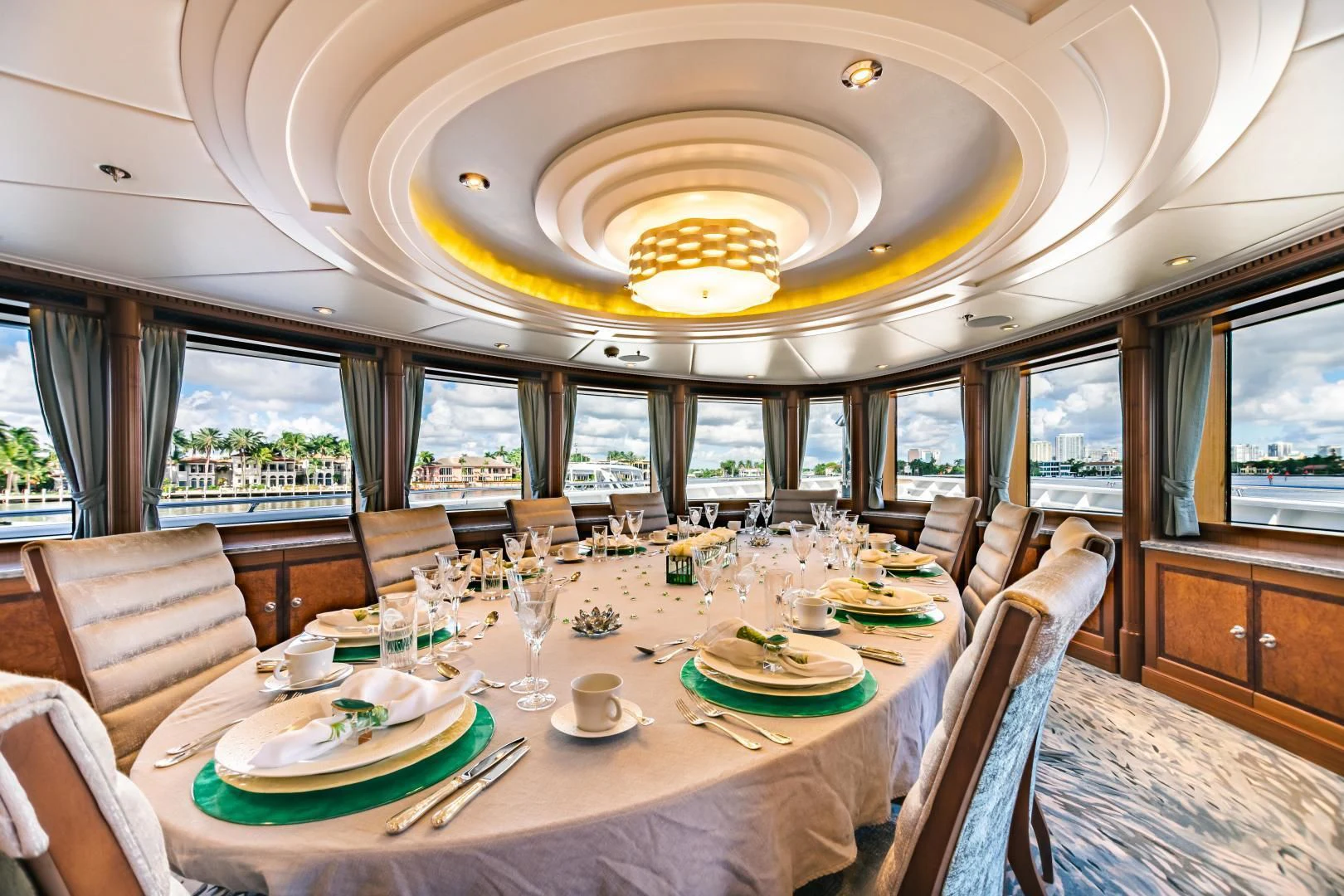 a dining room with a chandelier aboard ACTA Yacht for Charter
