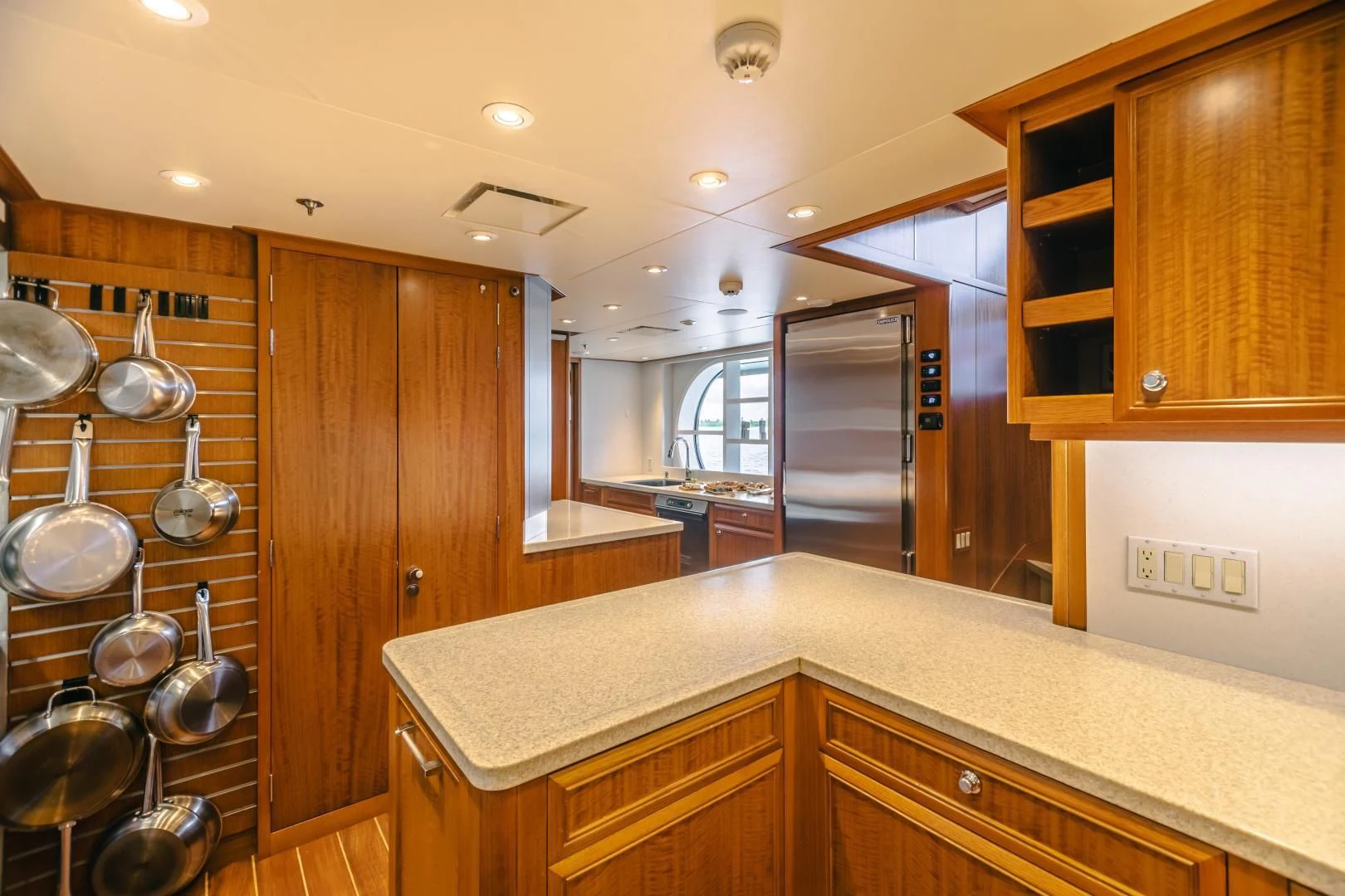 a kitchen with wooden cabinets aboard ACTA Yacht for Charter