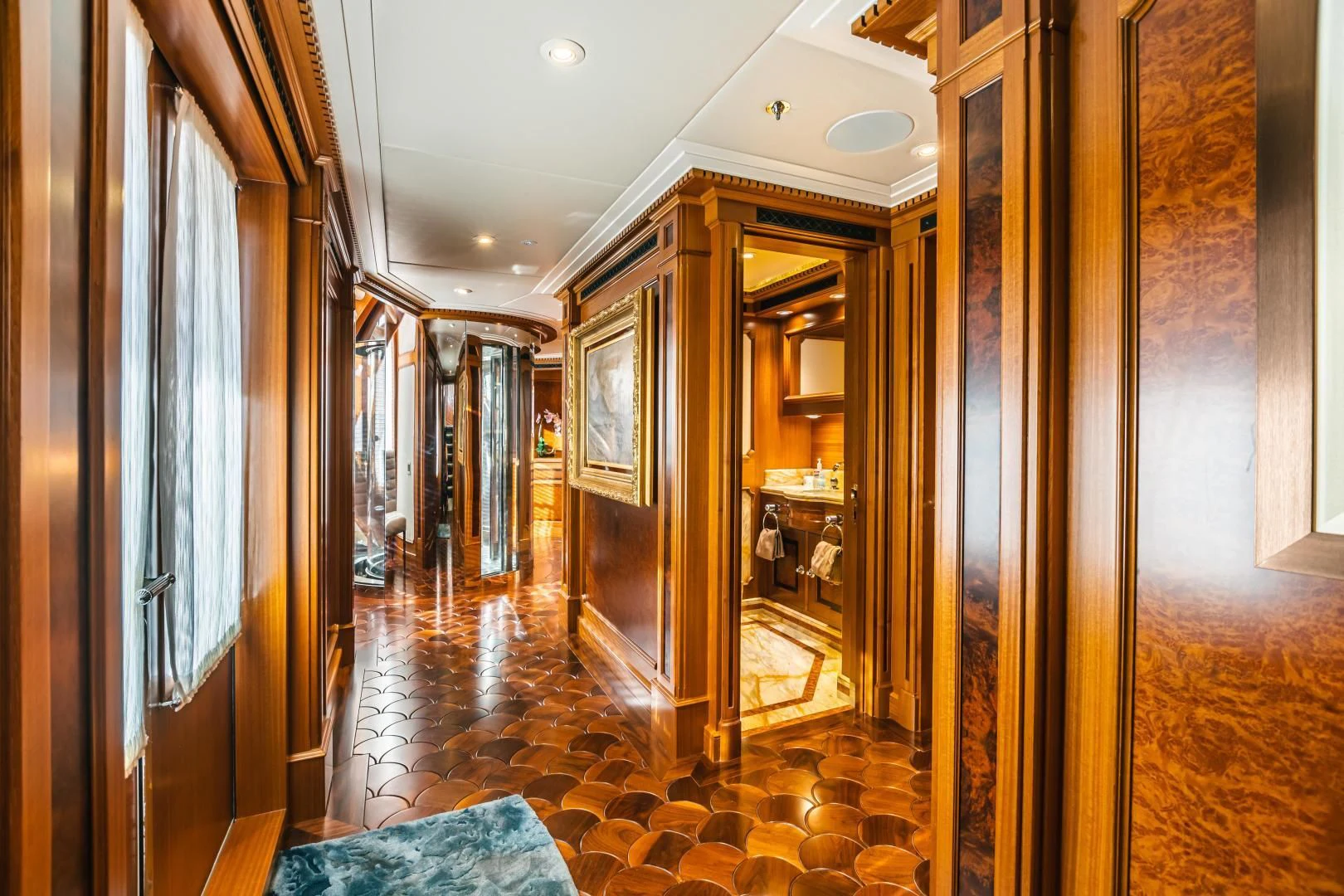 a hallway with a door and a mirror aboard ACTA Yacht for Charter