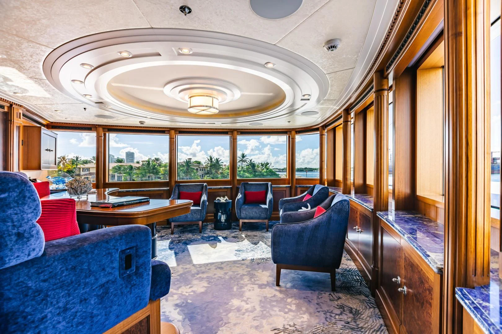 a room with a large chandelier aboard ACTA Yacht for Charter