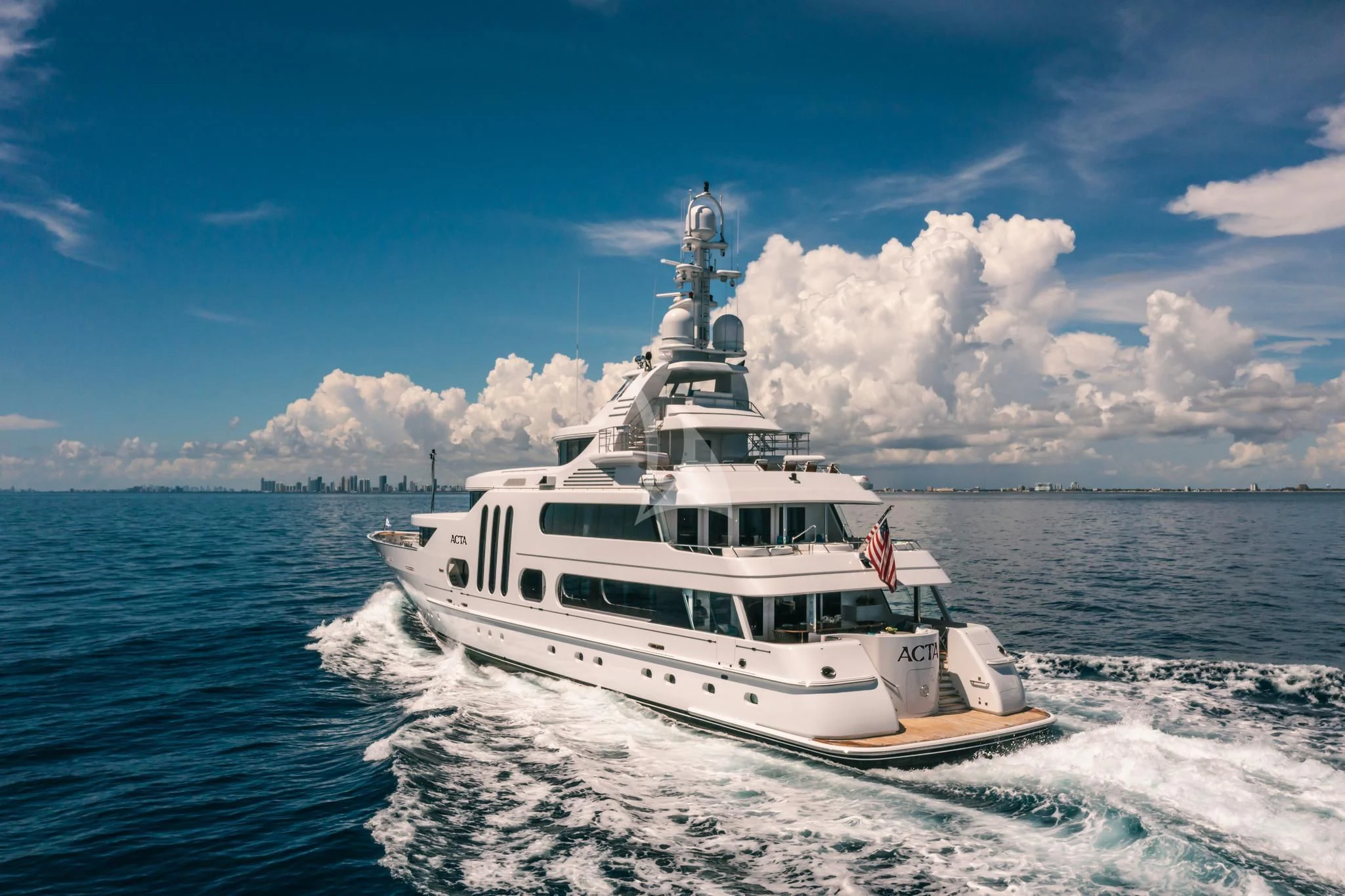 a white boat on the water aboard ACTA Yacht for Charter