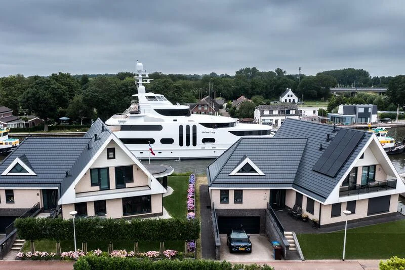 a group of houses with a parking lot in the background aboard ACTA Yacht for Charter