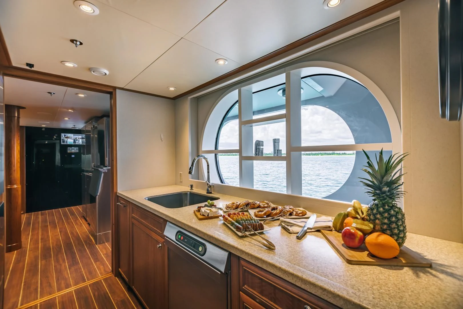 a kitchen with a large window aboard ACTA Yacht for Charter