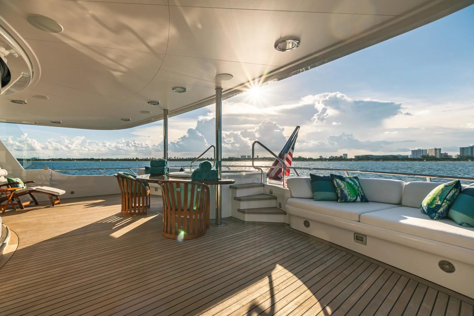 a room with a bed and a table and chairs aboard ACTA Yacht for Charter