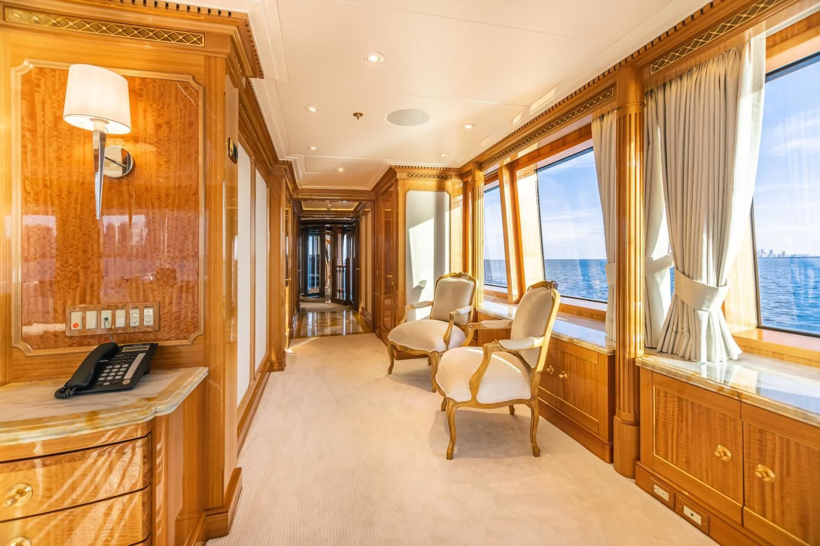 a large room with a desk and chairs aboard ACTA Yacht for Charter