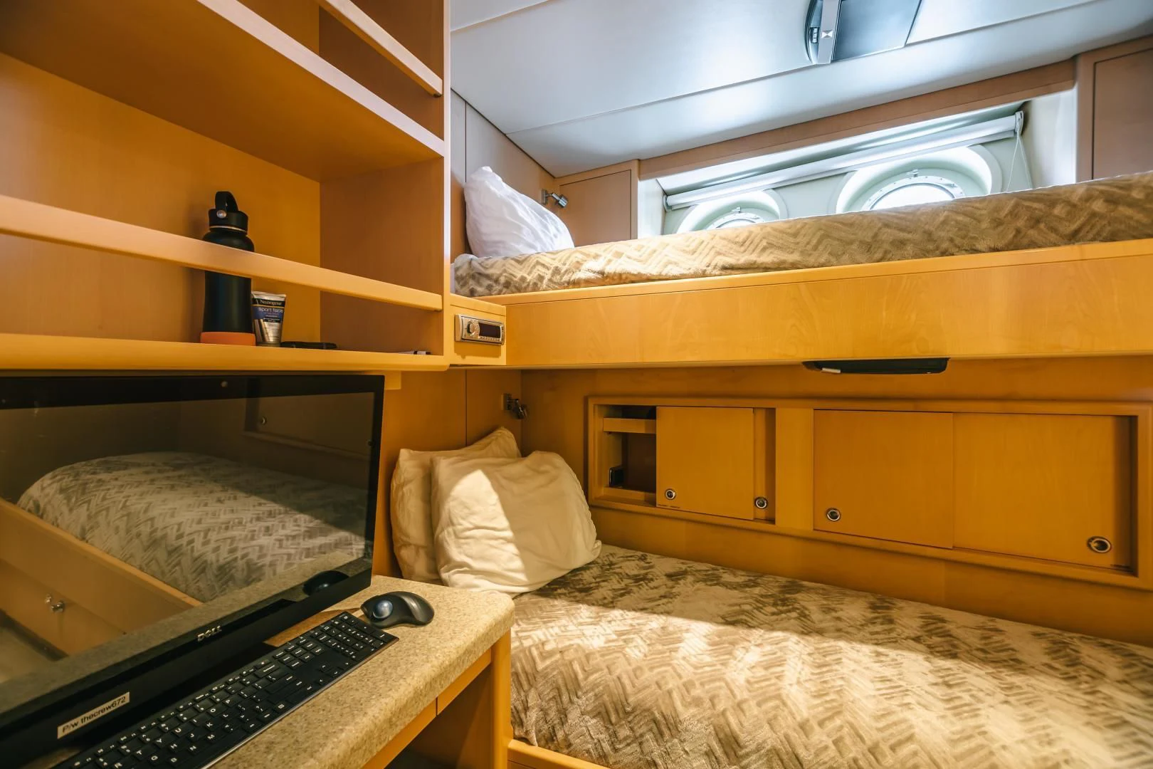 a bedroom with a bed and a desk aboard ACTA Yacht for Charter