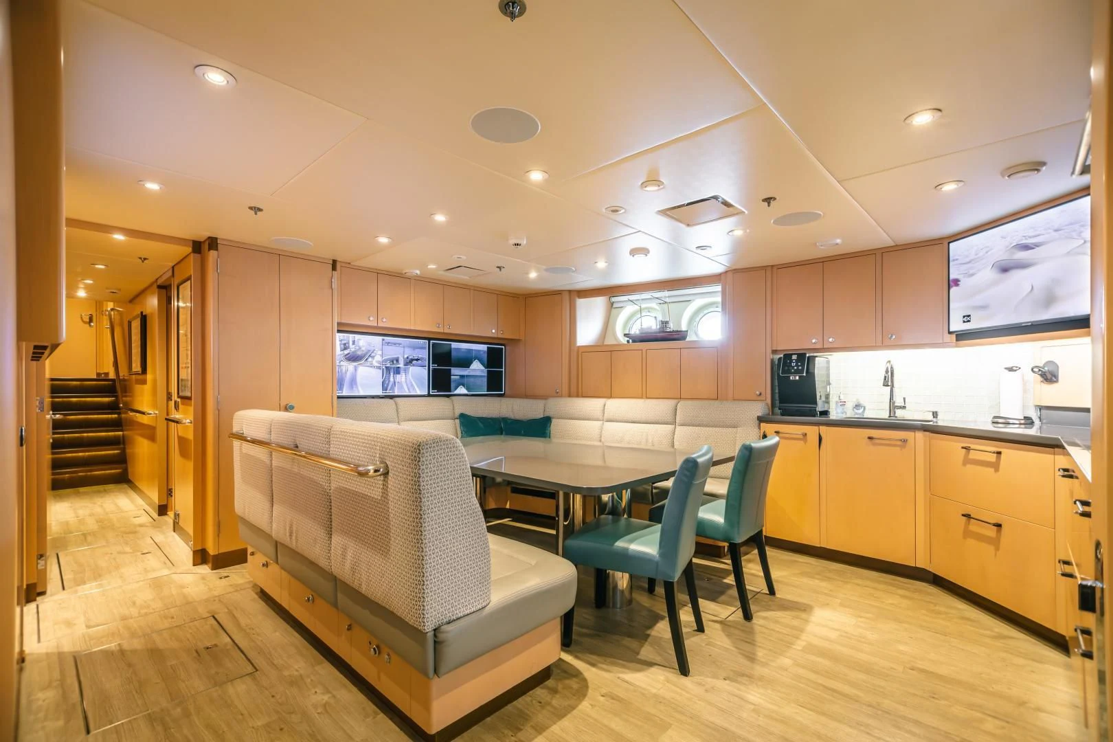 a large kitchen with a couch aboard ACTA Yacht for Charter