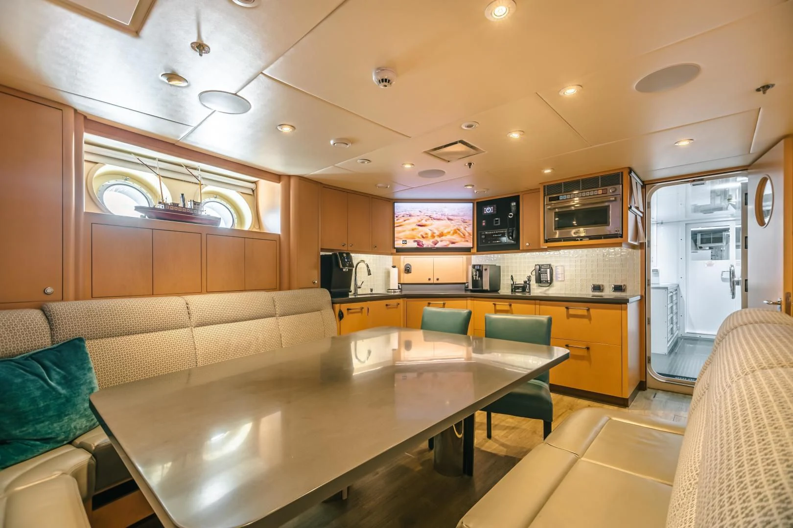 a kitchen with a table and chairs aboard ACTA Yacht for Charter