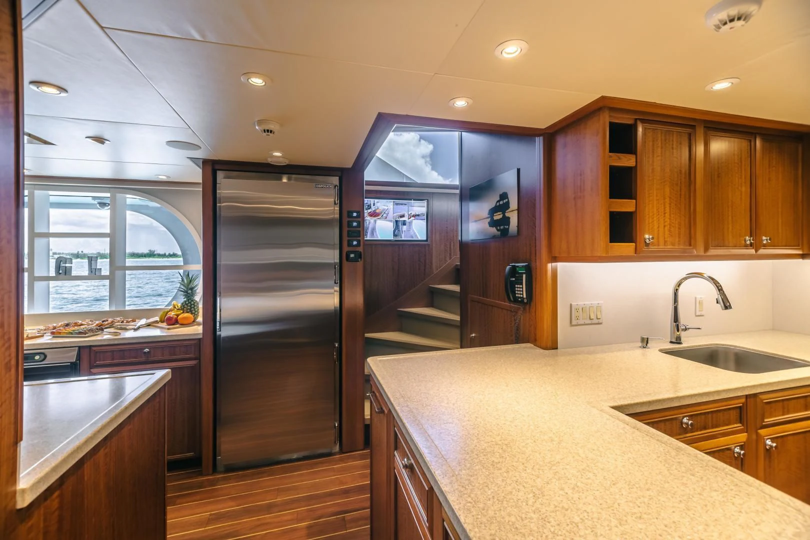a kitchen with wooden cabinets aboard ACTA Yacht for Charter