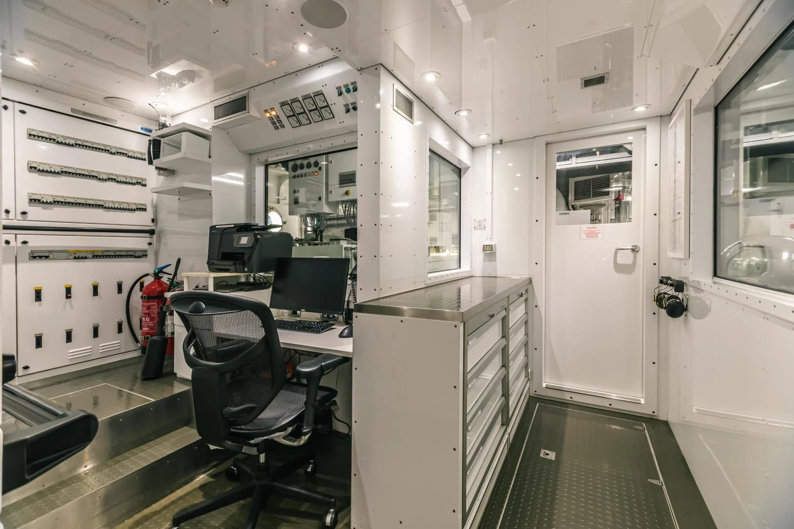 a room with a desk and chairs aboard ACTA Yacht for Charter