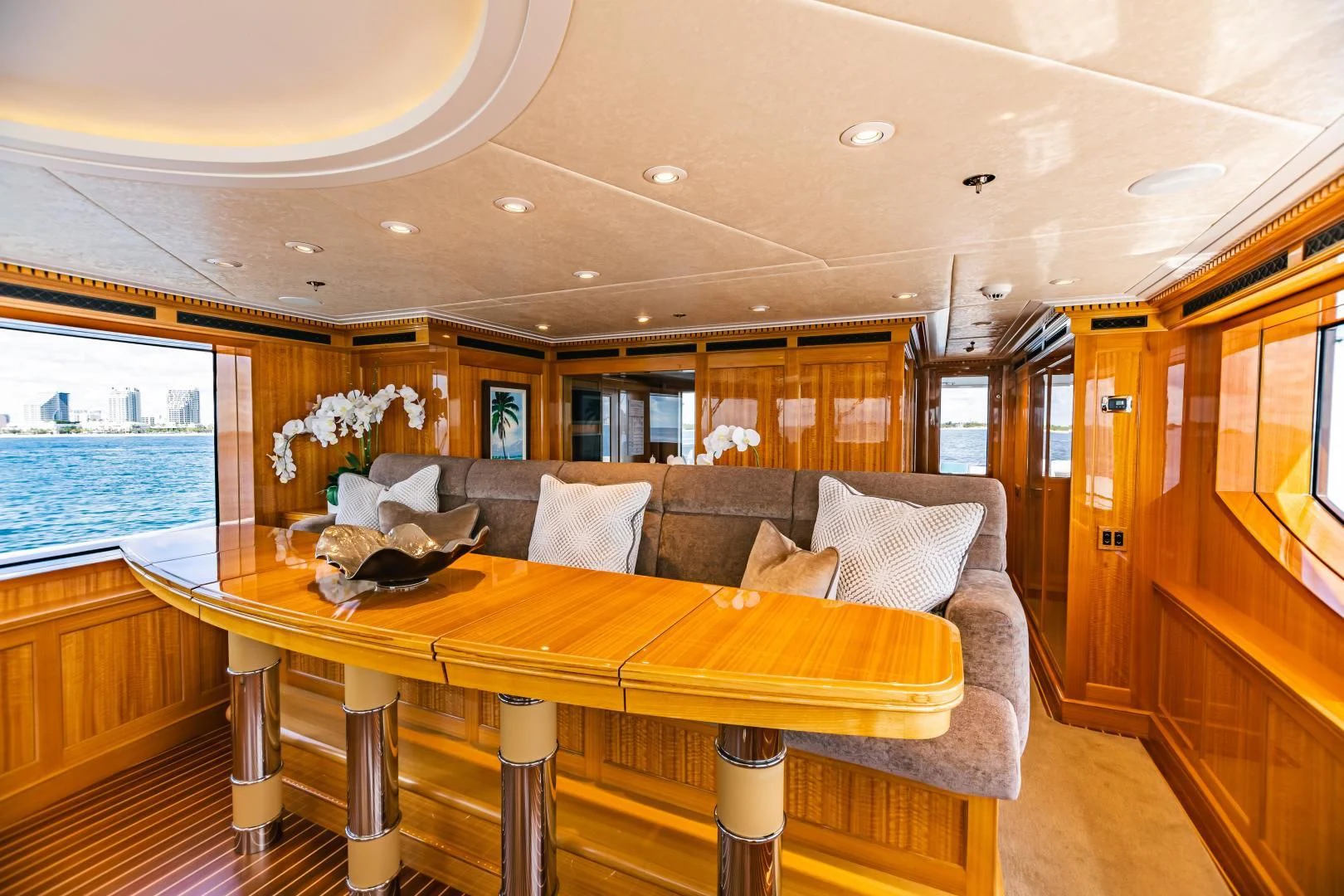 a large living room with a large couch and a large window aboard ACTA Yacht for Charter