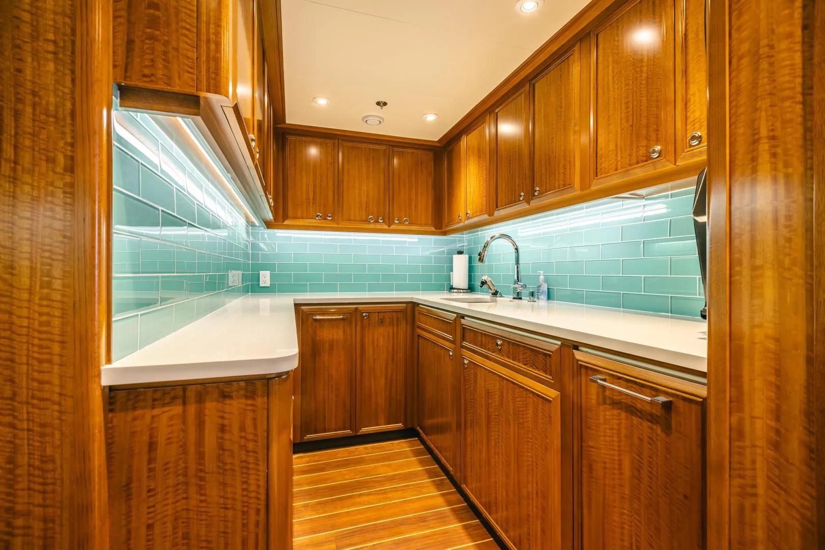 a kitchen with wooden cabinets aboard ACTA Yacht for Charter