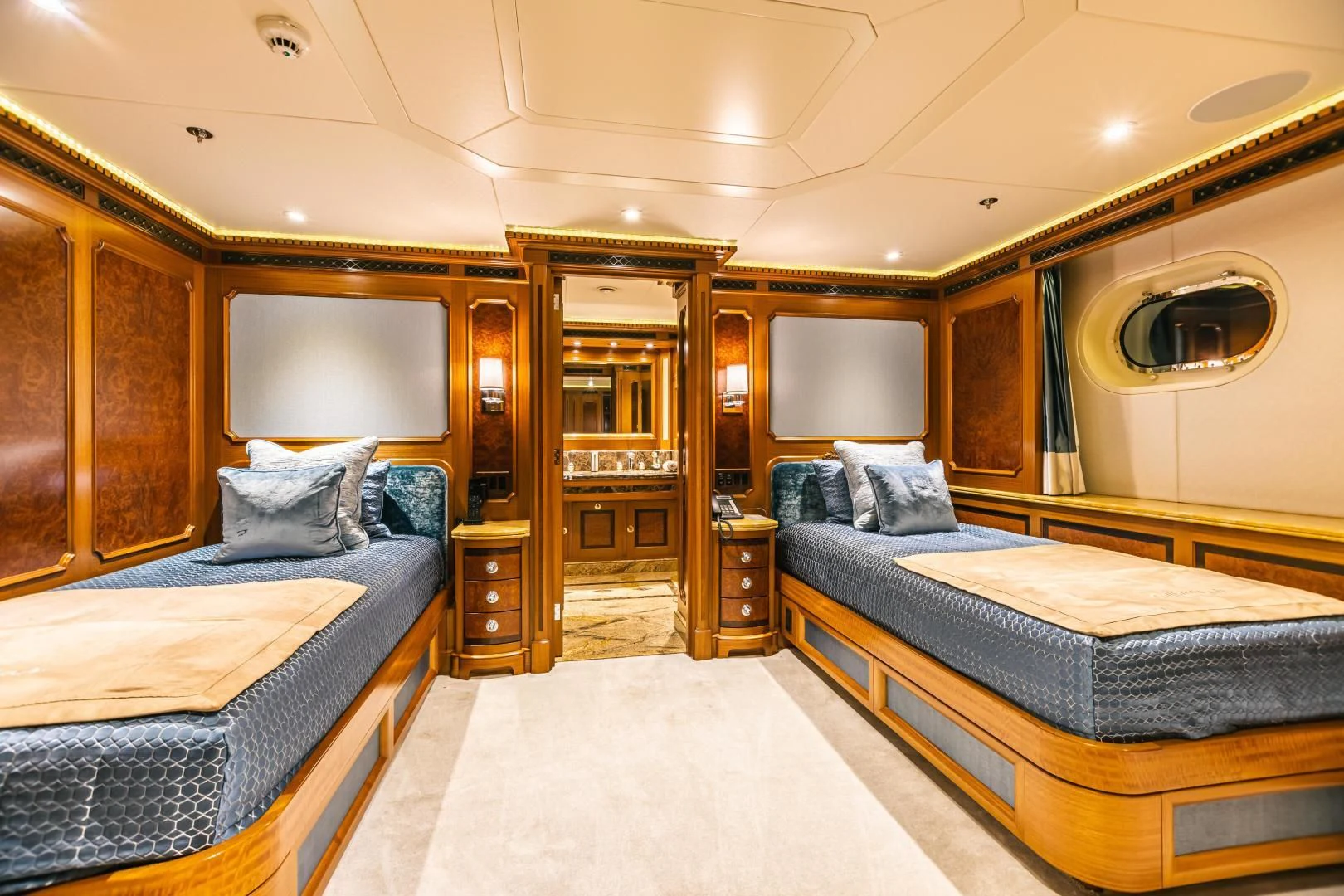 a bedroom with a bed and a mirror aboard ACTA Yacht for Charter