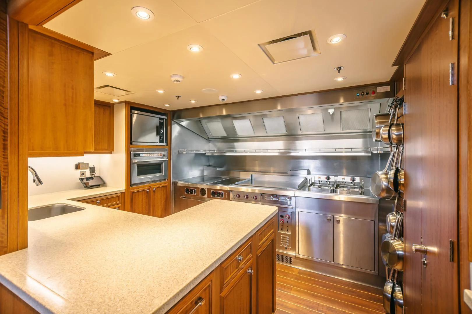 a kitchen with a large island aboard ACTA Yacht for Charter