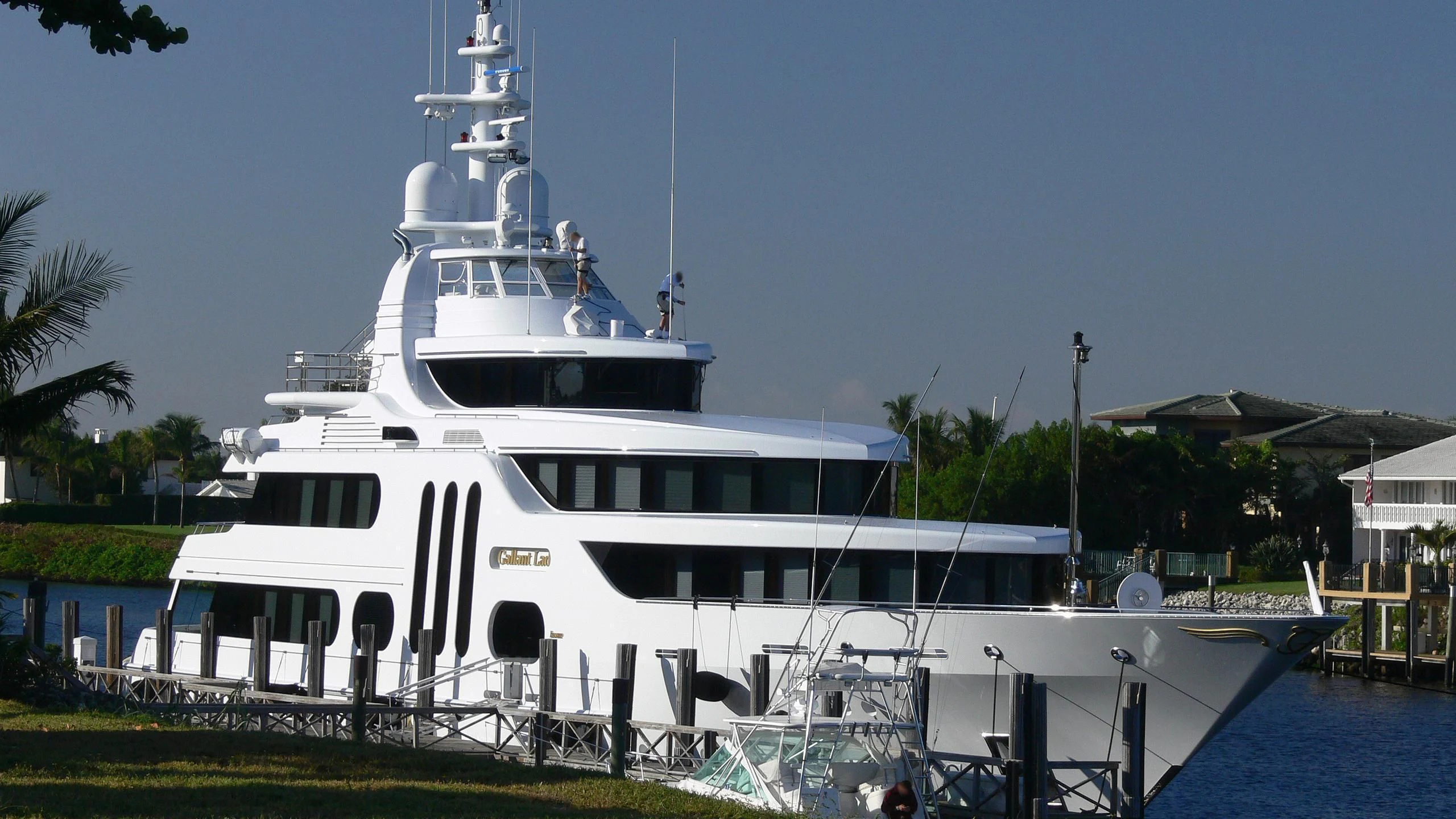 a white boat docked at a pier aboard ACTA Yacht for Charter