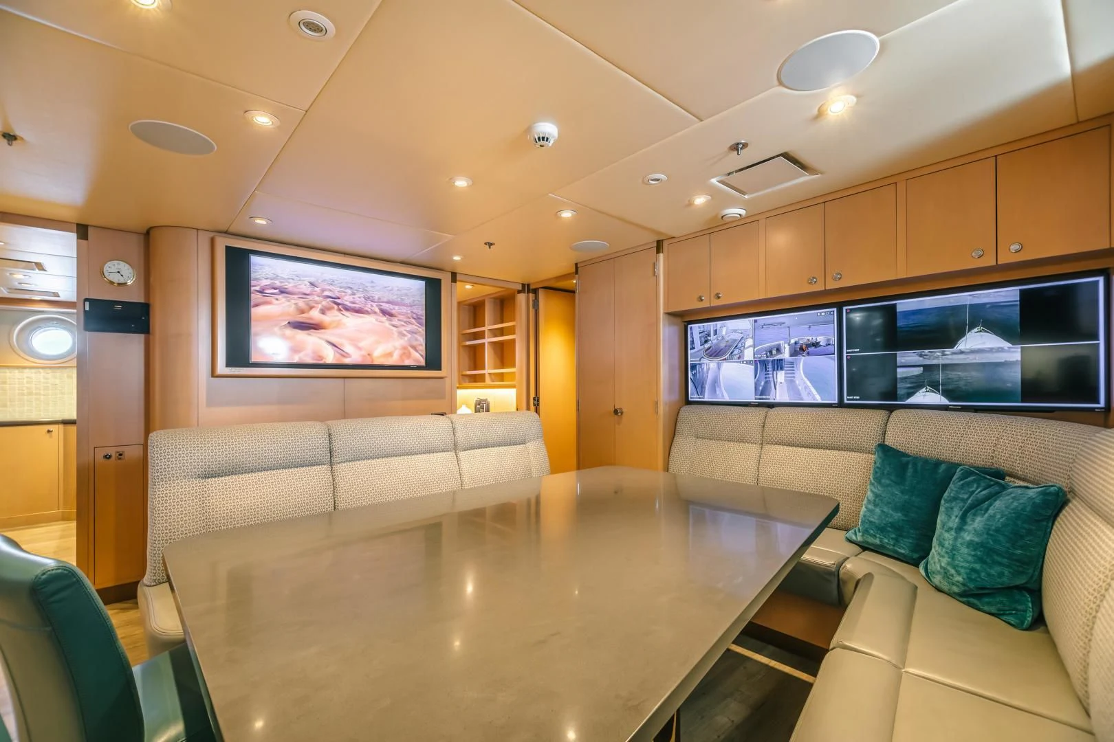 a living room with a table and tv aboard ACTA Yacht for Charter