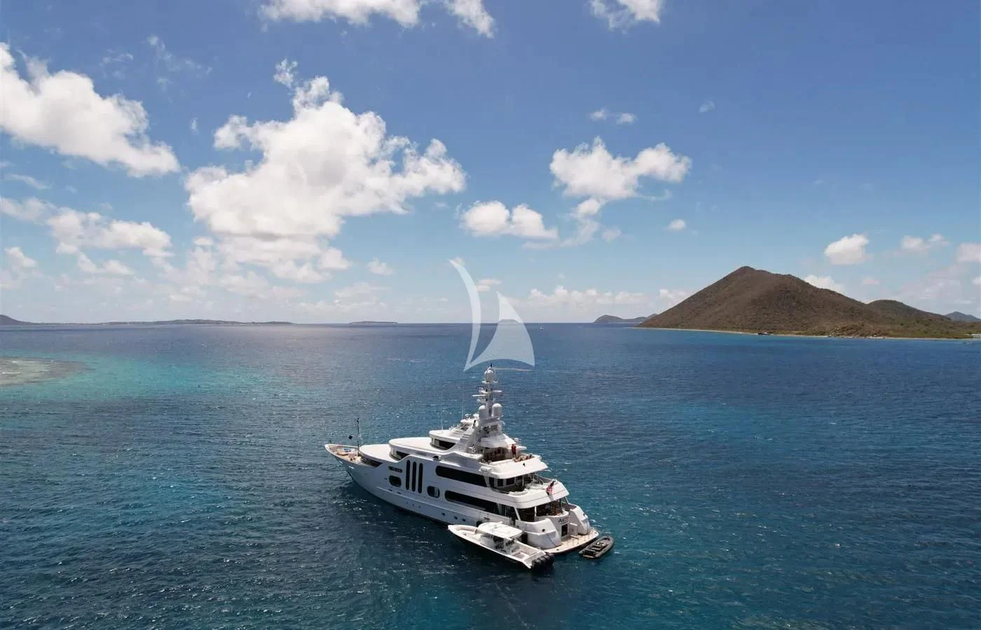 a boat in the water with a water fountain in the middle aboard ACTA Yacht for Charter
