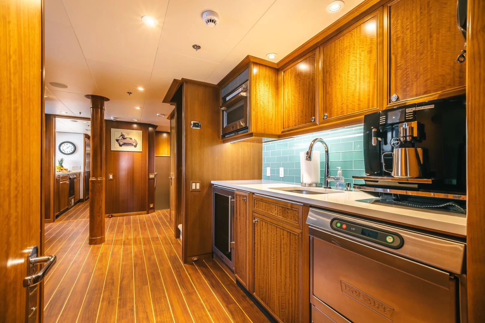 a kitchen with wooden cabinets aboard ACTA Yacht for Charter