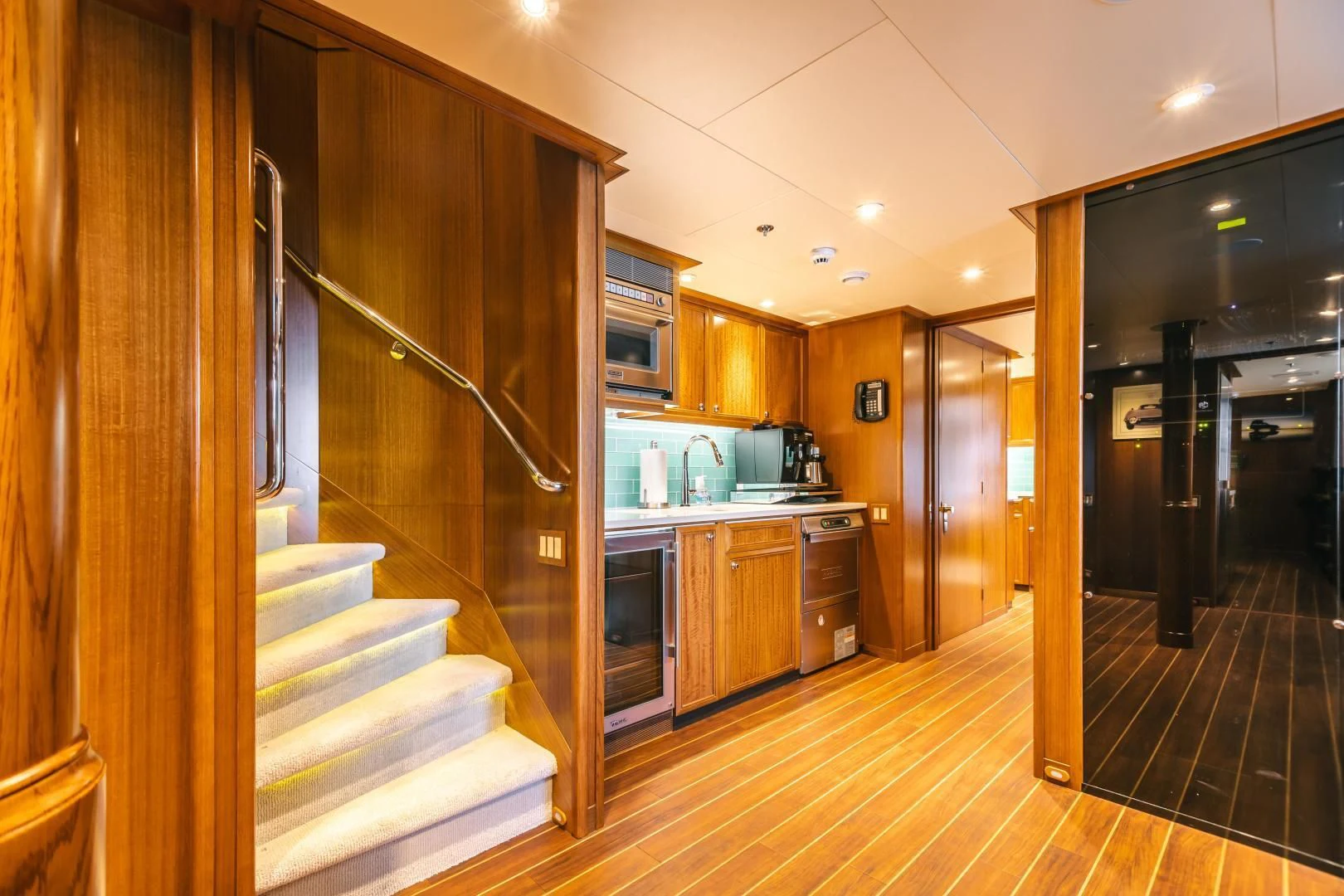a kitchen with a staircase and a staircase aboard ACTA Yacht for Charter