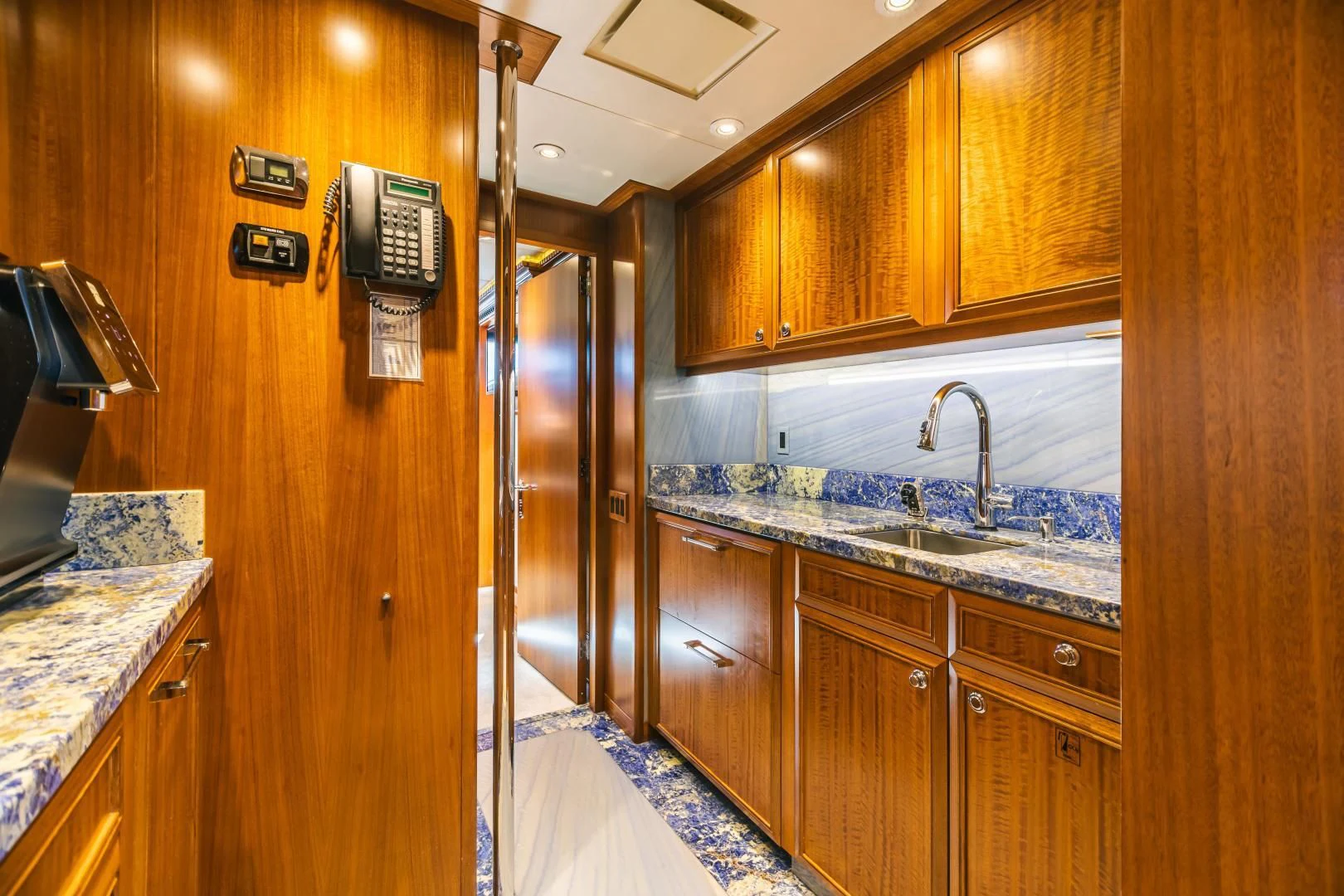a kitchen with wooden cabinets aboard ACTA Yacht for Charter