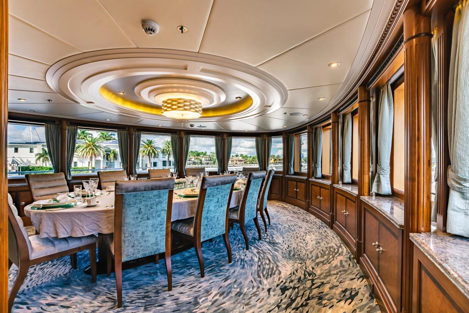 a large dining room with wood cabinets aboard ACTA Yacht for Charter