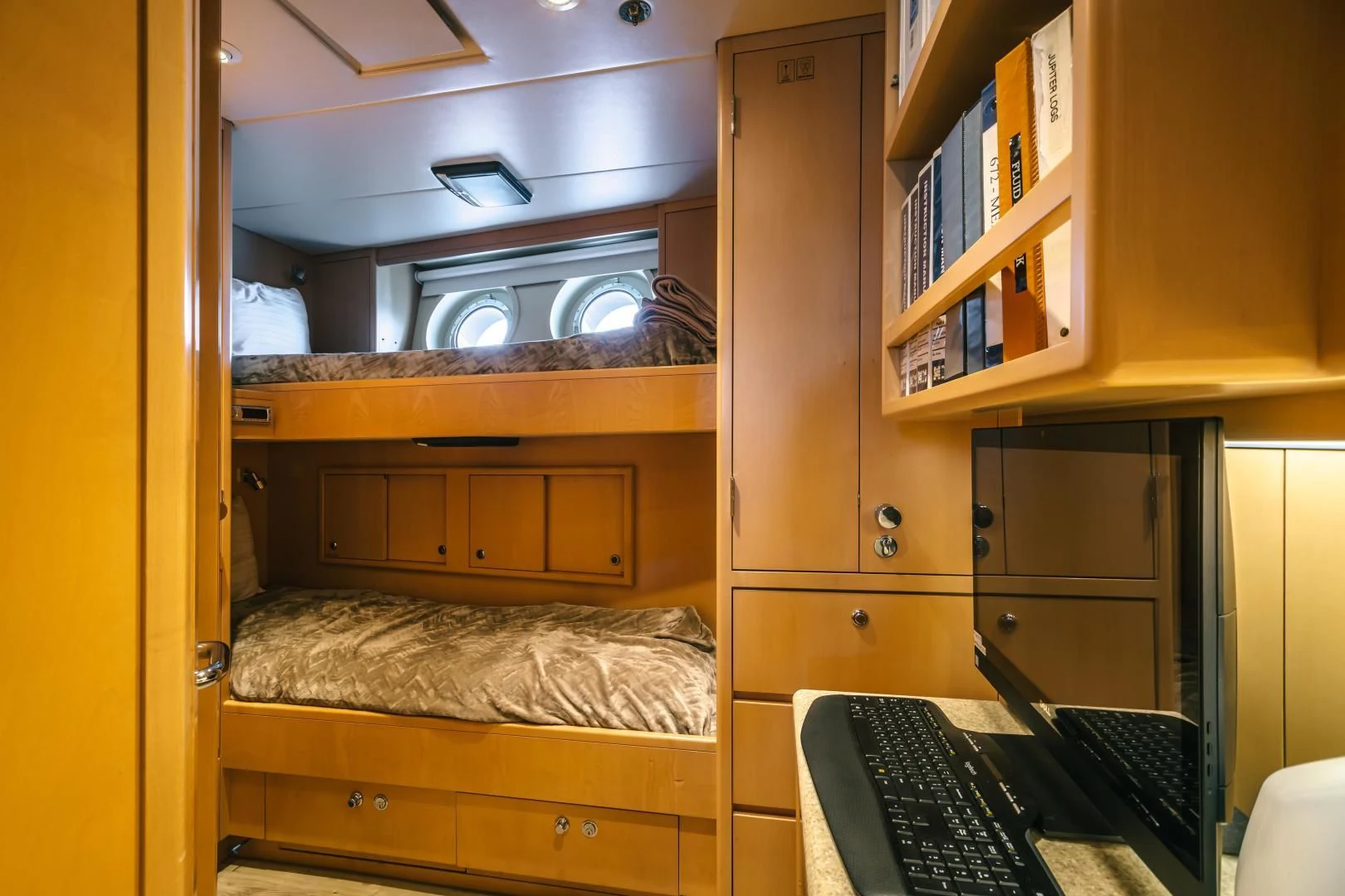 a room with a desk and a computer aboard ACTA Yacht for Charter