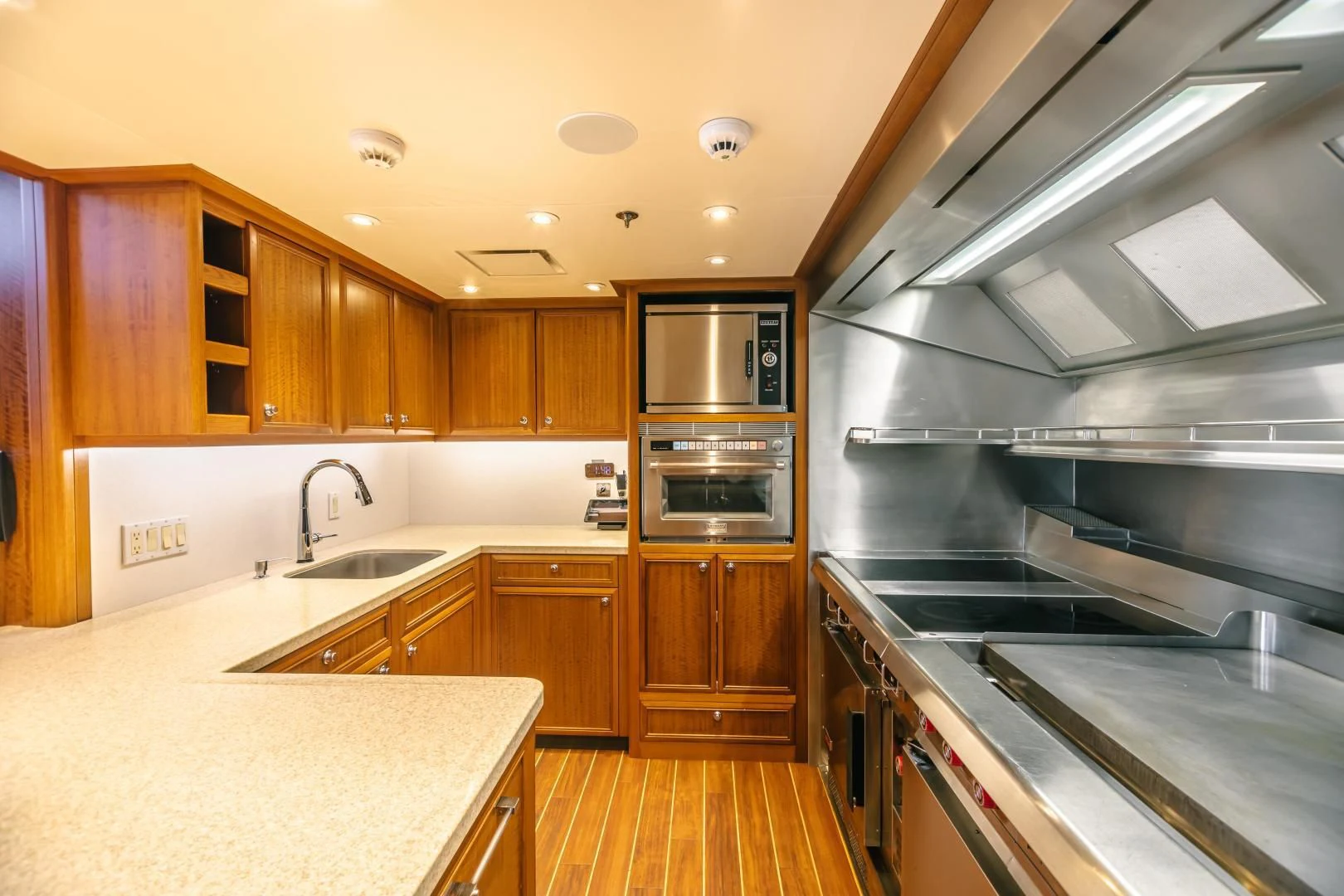 a kitchen with wooden cabinets aboard ACTA Yacht for Charter