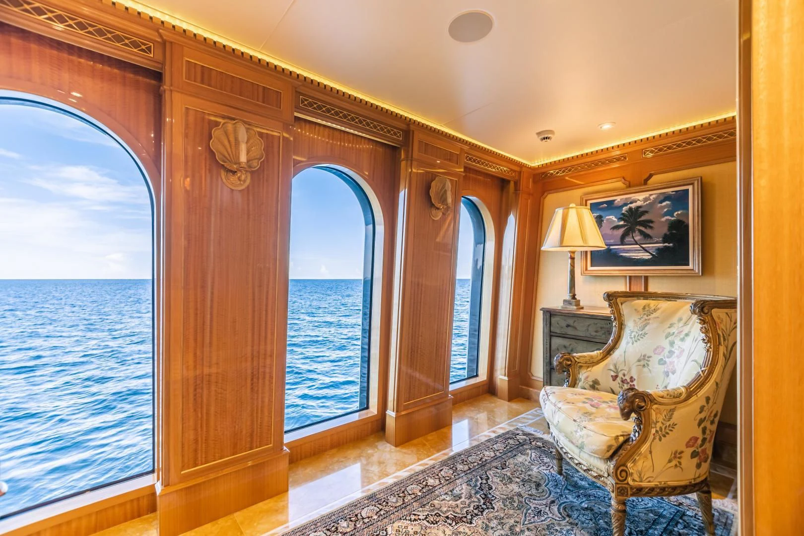 a room with a bed and a chair aboard ACTA Yacht for Charter