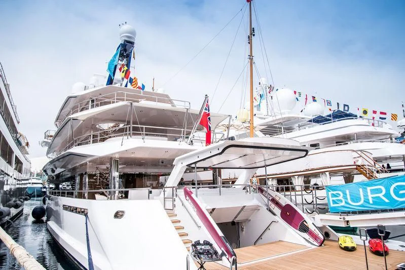 a large white boat with a flag on the front aboard JOY Yacht for Sale