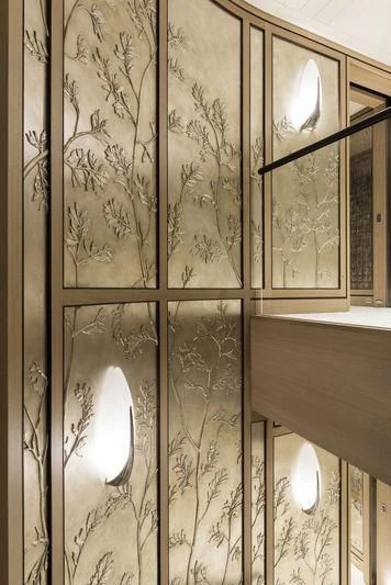 a room with a wall with art on it aboard JOY Yacht for Sale