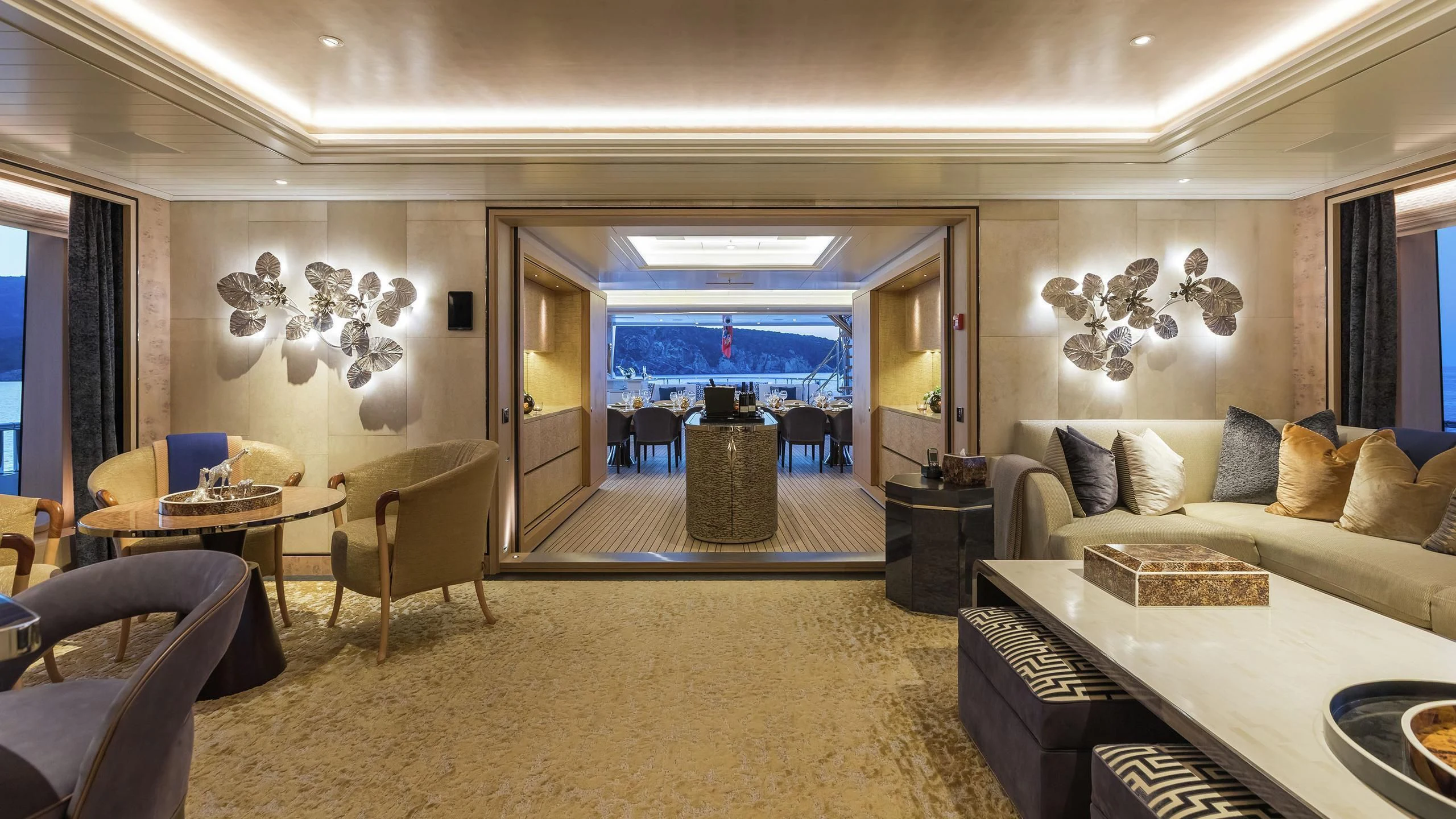 a living room with a large mirror aboard JOY Yacht for Sale