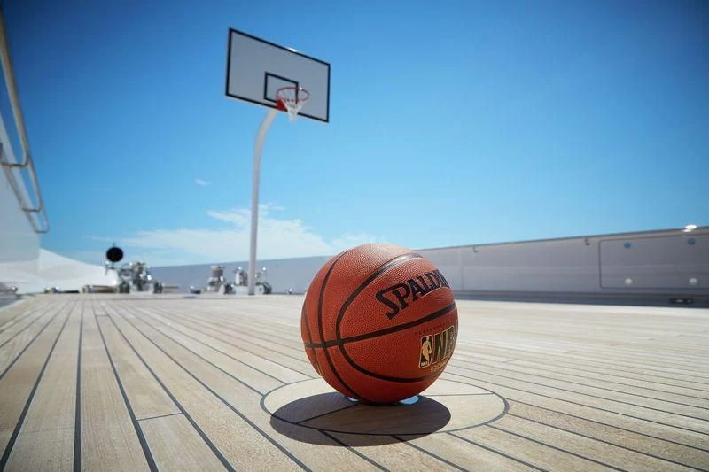 a basketball on a wooden deck aboard JOY Yacht for Sale