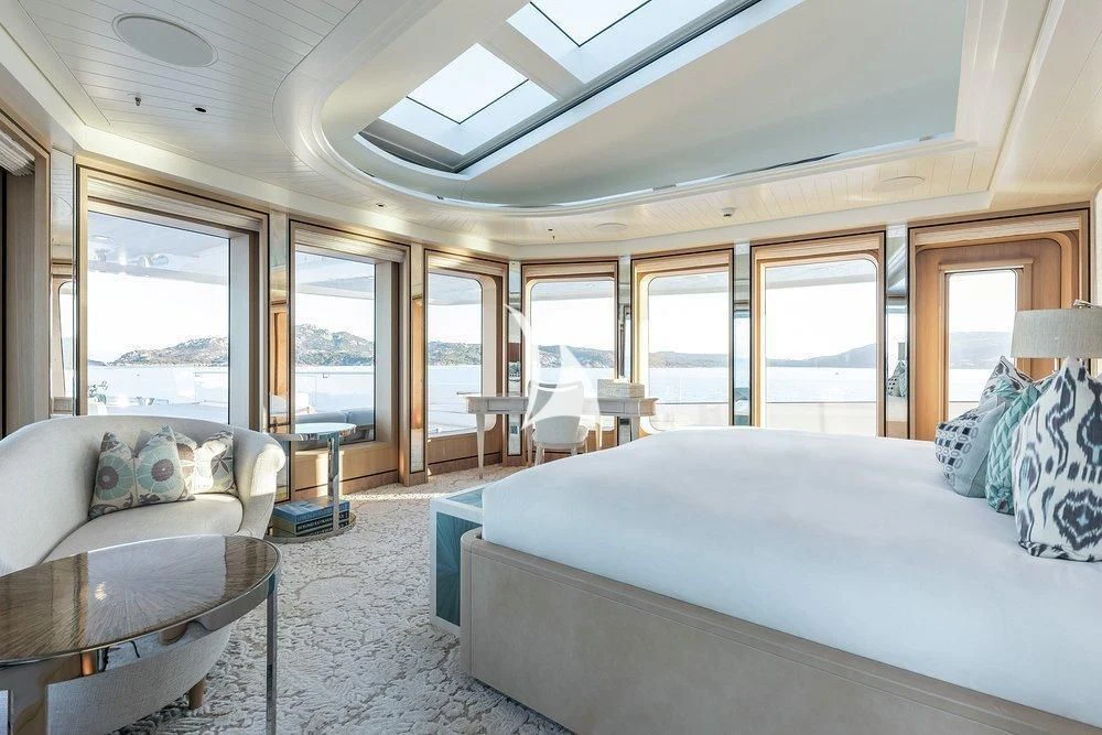 a bedroom with a bed and a couch aboard JOY Yacht for Sale