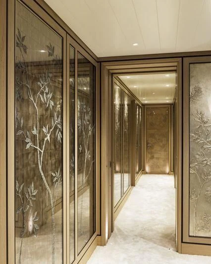 a hallway with glass doors aboard JOY Yacht for Sale