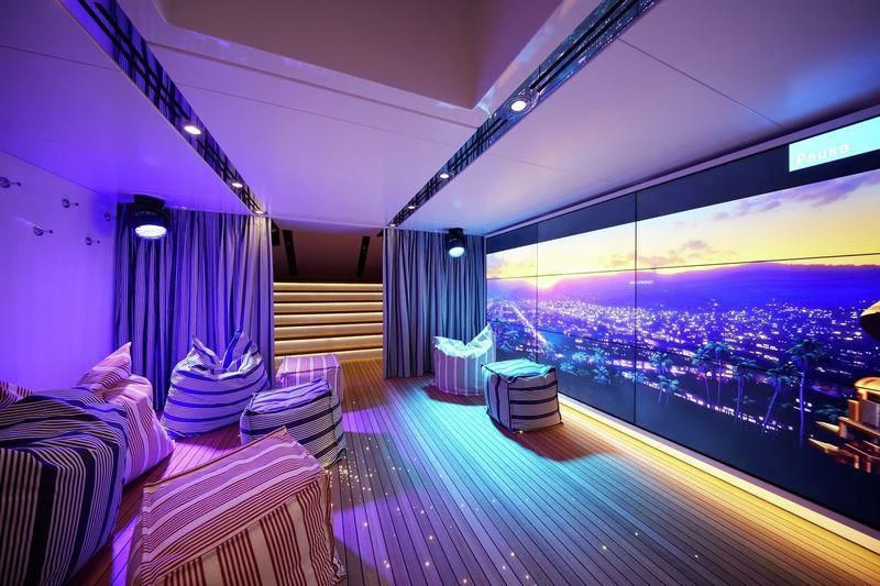 a room with a view of a city and a large window aboard JOY Yacht for Sale