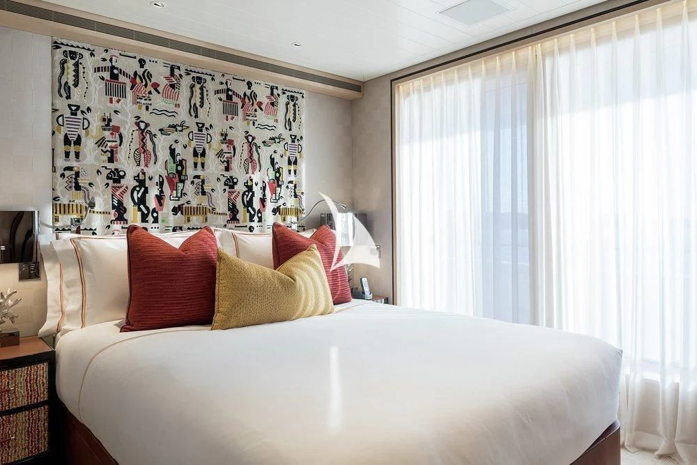 a bed with pillows aboard JOY Yacht for Sale