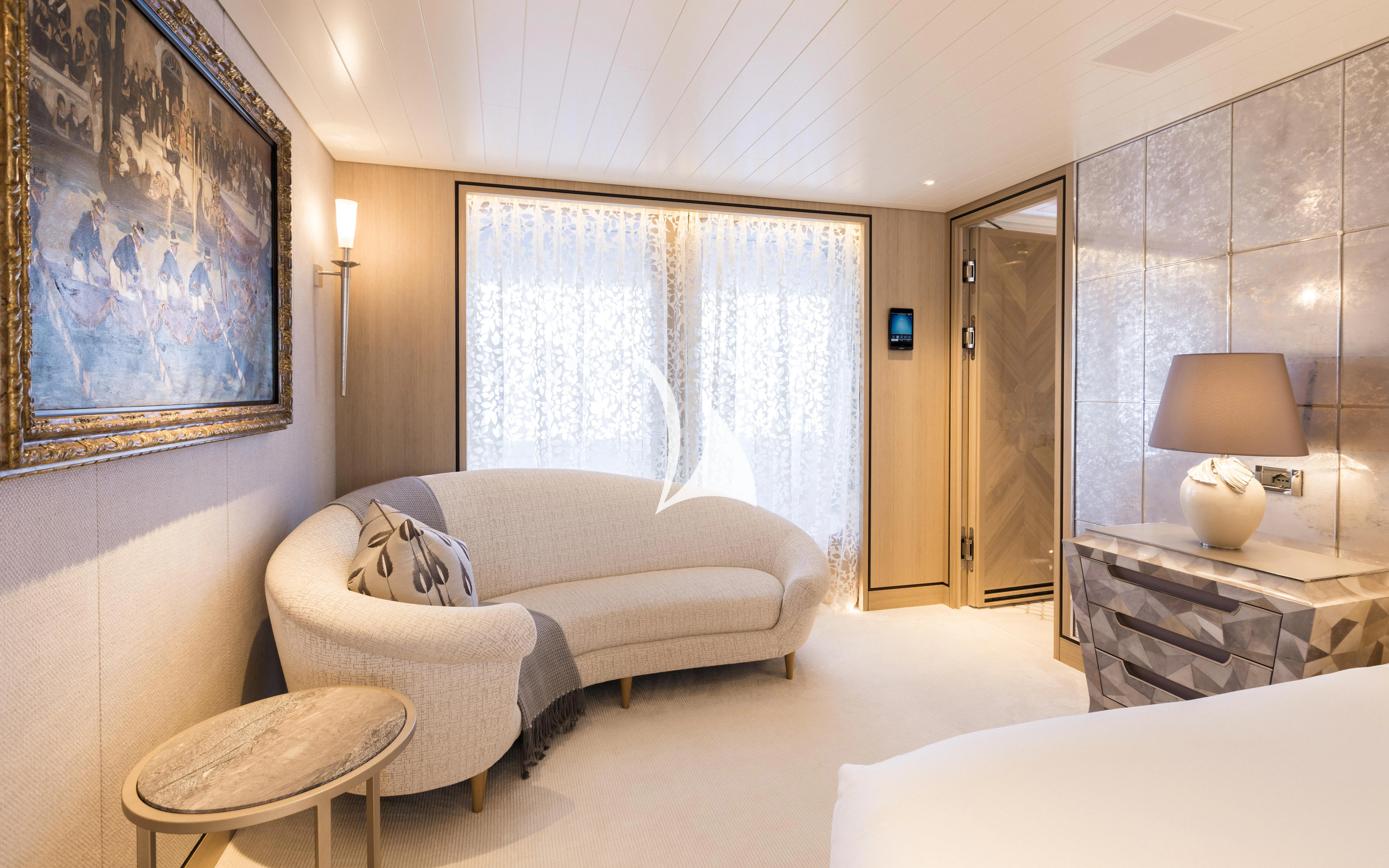 a room with a bed and a table aboard JOY Yacht for Sale