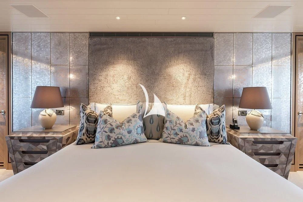 a bed with pillows aboard JOY Yacht for Sale