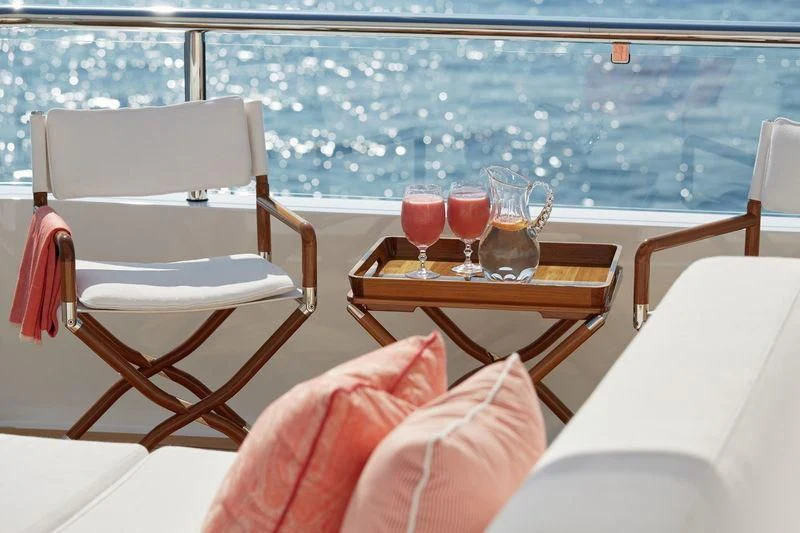 a table with glasses on it aboard JOY Yacht for Sale