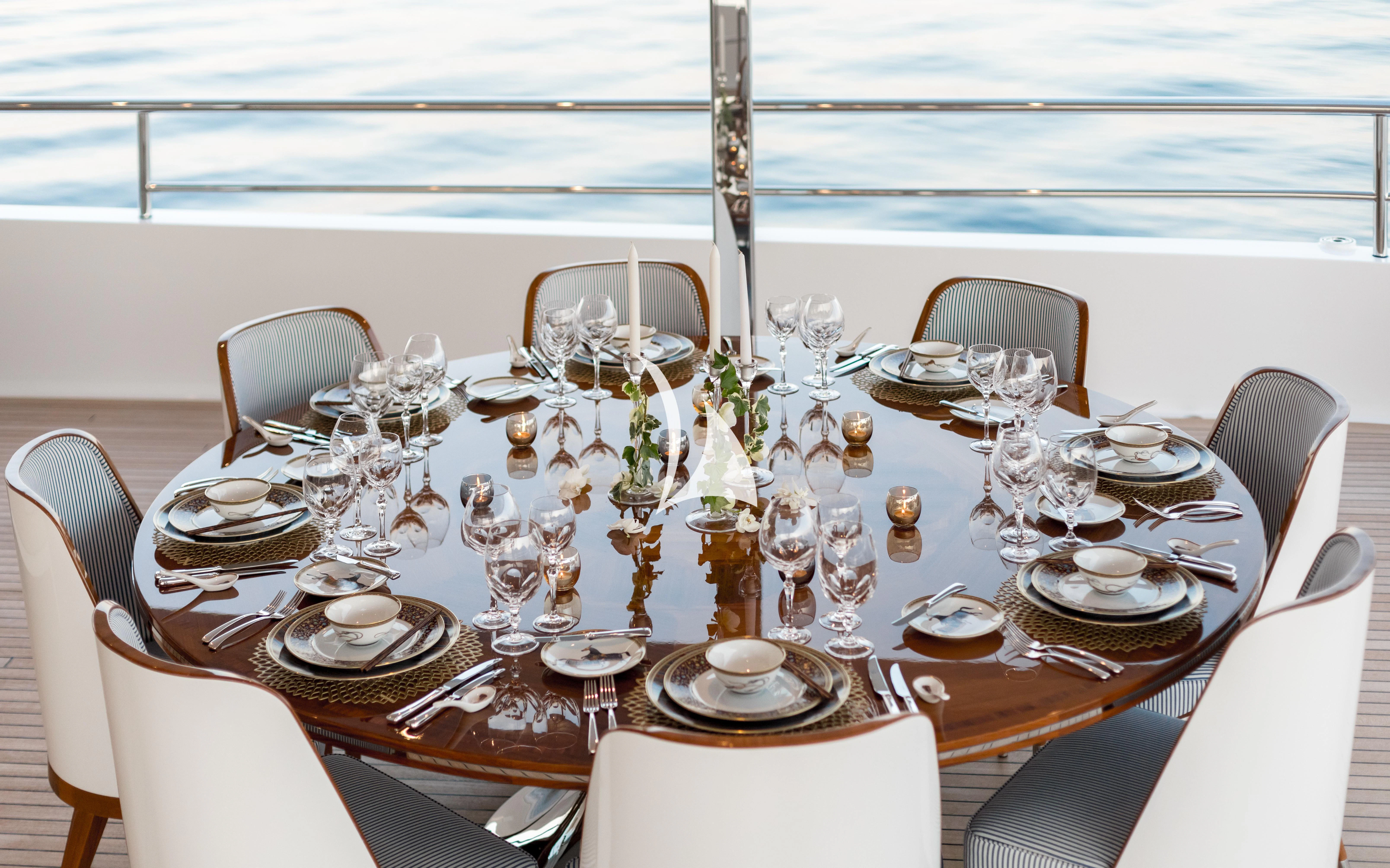 a table set with silverware aboard JOY Yacht for Sale