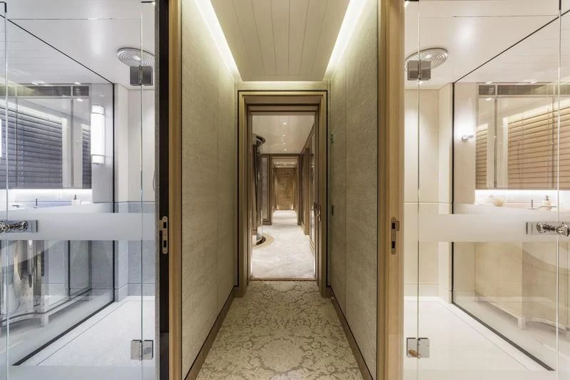 a hallway with glass doors aboard JOY Yacht for Sale