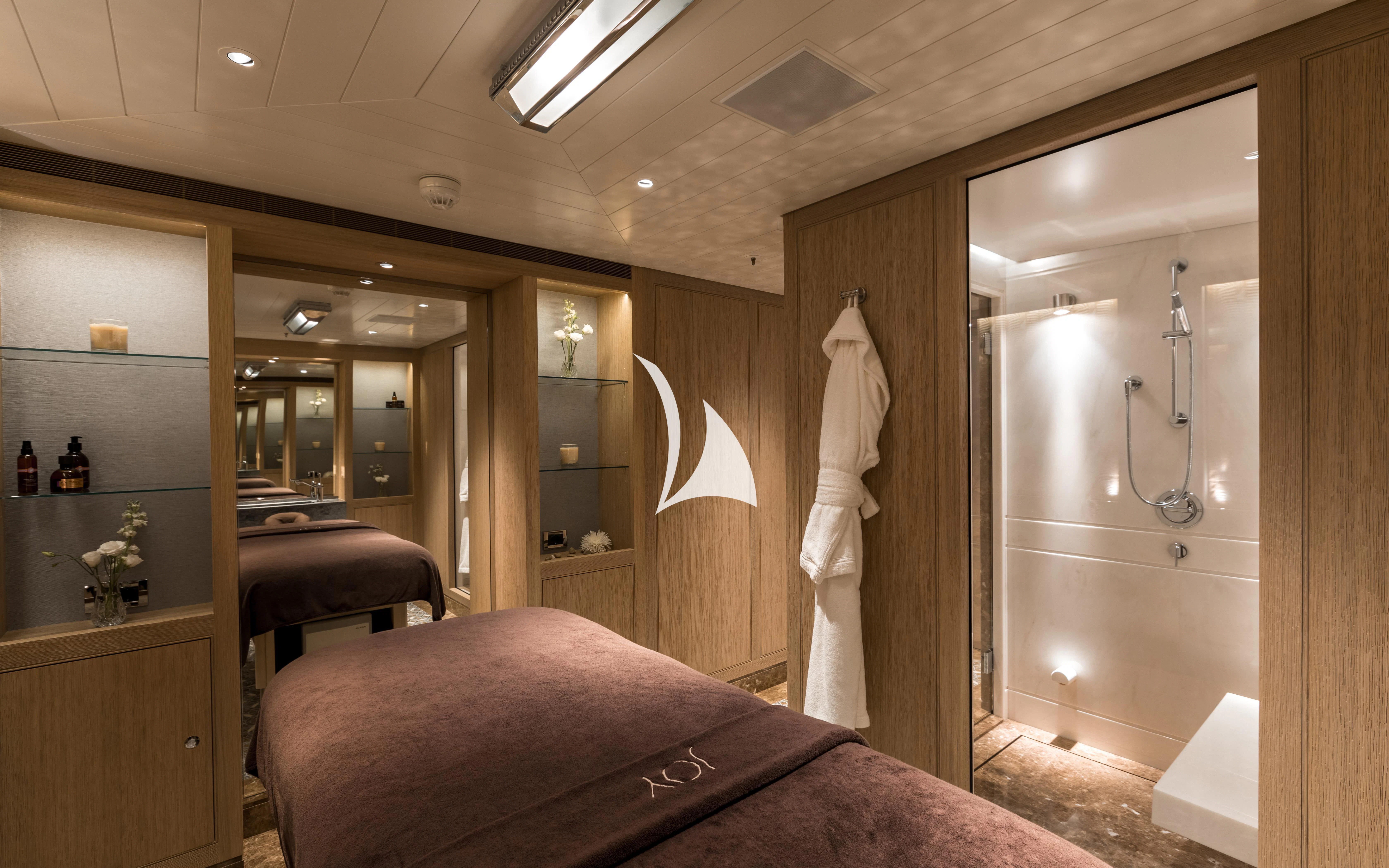 a robe on a bed aboard JOY Yacht for Sale
