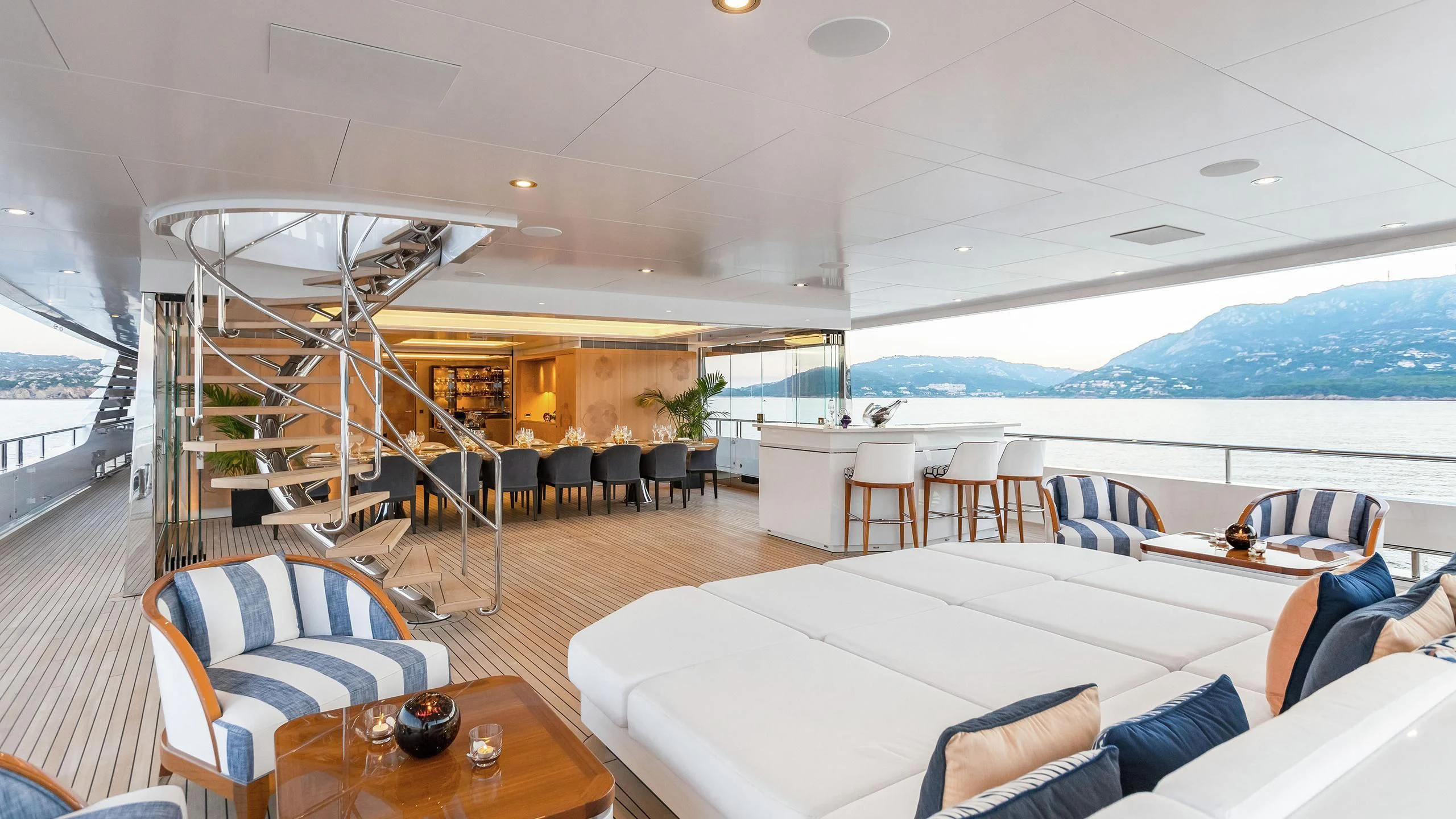a room with a table chairs and a large window aboard JOY Yacht for Sale