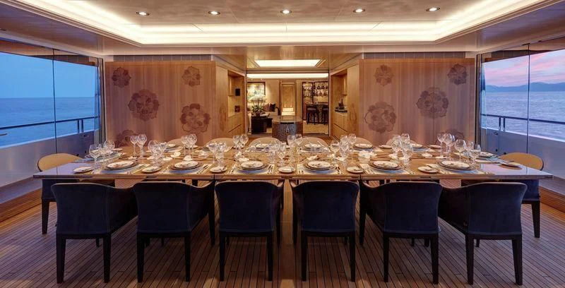 a large dining room table aboard JOY Yacht for Sale